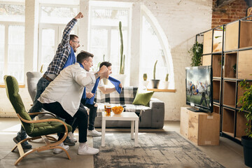 Group of friends watching sport match together. Concept of friendship, leisure activity, emotions