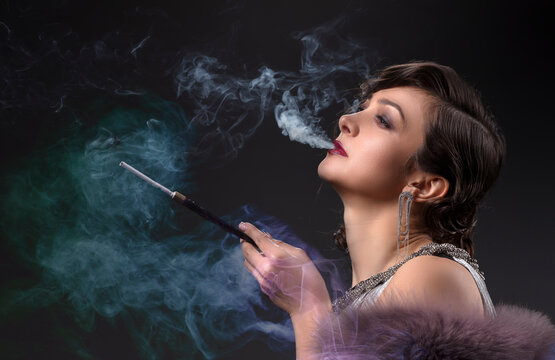 Retro woman portrait. Beautiful woman in the style of 20s or 30s with a mouthpiece in colored smoke.