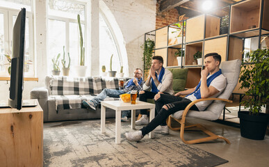 Group of friends watching sport match together. Concept of friendship, leisure activity, emotions