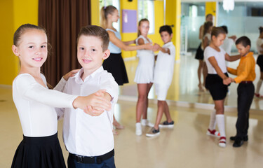 Portrait of smiling children enjoying of partner dance in class