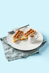 Oatmeal Belgian waffles in pencil shape on blue table