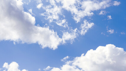 Naklejka na ściany i meble blue sky with white clouds backlit by sunlight
