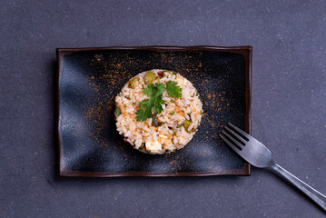 simple italian spring risotto on dark background with bottarga on dark background. spring season italian food