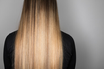 Rear view of long hair with balayage. Soft focus