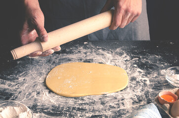 Chef's hands prepare dough for pizza. Fresh natural healthy food