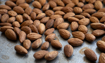 roasted almonds are on a baking sheet. Homemade almonds, protein, healthy nuts. Almond kernels