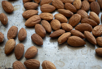 roasted almonds are on a baking sheet. Homemade almonds, protein, healthy nuts. Almond kernels