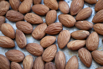 roasted almonds are on a baking sheet. Homemade almonds, protein, healthy nuts. Almond kernels