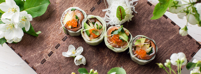 healthy kale and avocado sushi roll with chopsticks