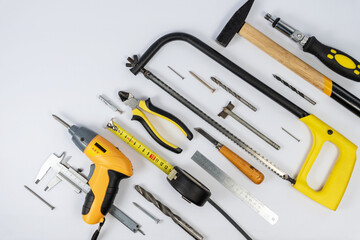 Repair tools and various parts on a white background top view.