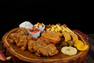 Cuban filet. Made with Breaded Steak, Banana, Breaded Cheese and Ham, French Fries with Bacon. Accompanies Red Tomato Vinaigrette, select vegetables, white rice, peach pineapple and Fig.
