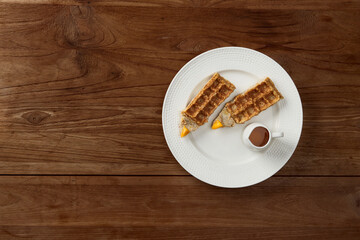 Oatmeal Belgian waffles in pencil shape on rustic wooden table. Flat lay top view