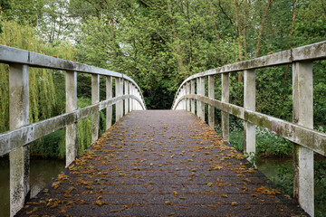 Symmetrical lines of the old, white, isolated wooden bridge in the city of Breda, North Brabant