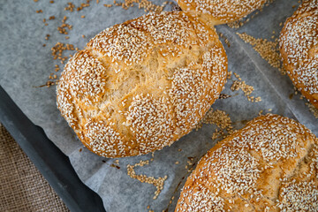 Fresh challah bread rolls hot from the oven on baking tray. Gluten free bread buns or mini loaves...
