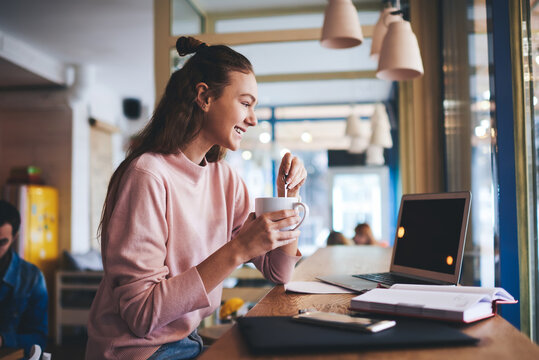 Happy Woman Stirring Coffee During Break