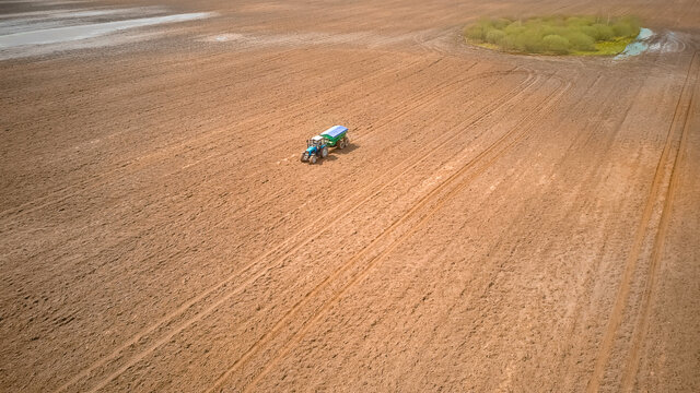 Photo From A Tractor Drone Sowing Seeds In A Field. Process Of Planting Seeds In The Ground As Part Of An Early Spring Agricultural Activity