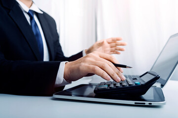 Business women working together at office desk, hands close up with calculator out financial data. teamwork workplace strategy Concept.