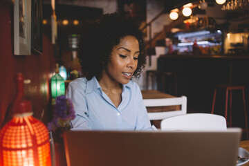 Woman working with laptop in cafe