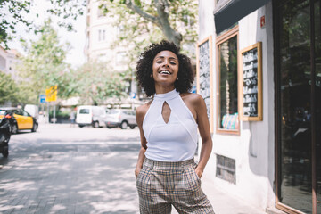 Happy young black woman on street