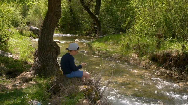Little boy fishing in a river