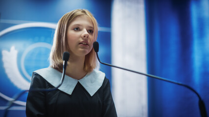 Portrait of an Young Girl Activist Delivering an Emotional and Powerful Speech at a Press Conference in Government Building. Child Speaking to Congress at Summit Meeting with World Leaders.