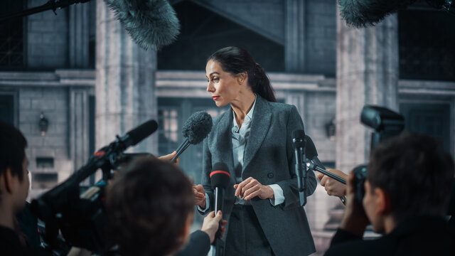 Organization Representative Answering Press Questions and Giving Interview Outside a Parliament, Court or Other Government Building. Press Officer or Businesswoman Crowded by News Journalists. 
