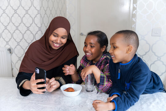 Black Muslim mother spending time with daughter and son