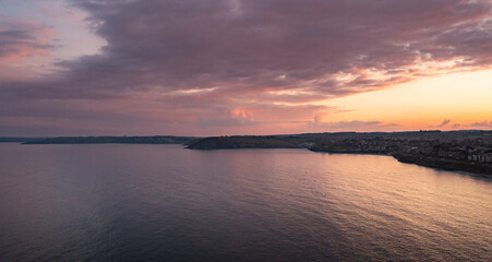 Fototapeta na wymiar Beautiful Red sunset over the sea and coastline 