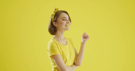 Stylish young woman on yellow background