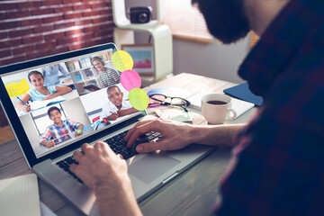 Fototapeta premium Caucasian businessman sitting at desk using laptop having video call