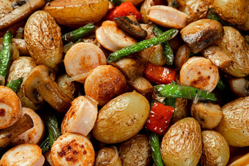 Close up baked vegetables asparagus bean, pepper, mushrooms and sausage, horizontal orientation.