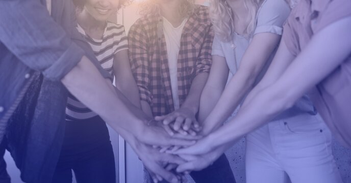 Composition of light over group of young businesspeople teaming up