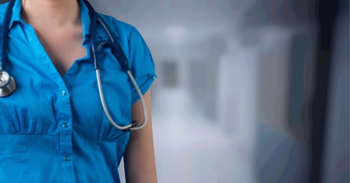 Composition of midsection of female doctor with stethoscope over out of focus hospital