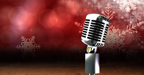 Vintage microphone on a stand over red snowflakes background, performance and holiday concepts