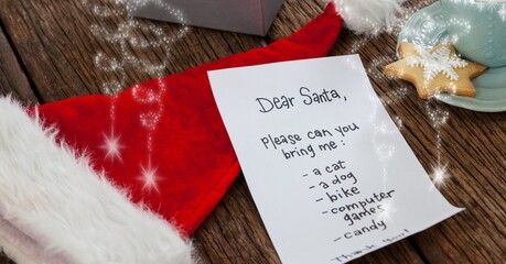 Composition of letter to santa over santa claus hat and christmas decorations