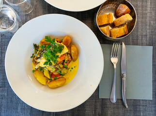 Hake fillet with vegetables and potatoes. French dish. High quality photo