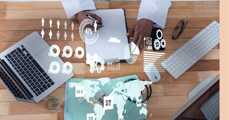 Digital interface with data processing over mid section of doctor taking notes