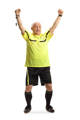 Full length portrait of a mature football referee cheering with hands up