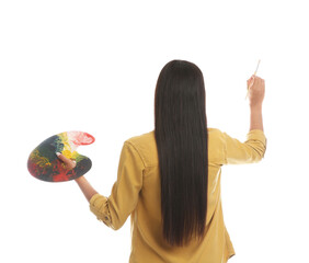 Fototapeta premium Young woman drawing with brush on white background, back view