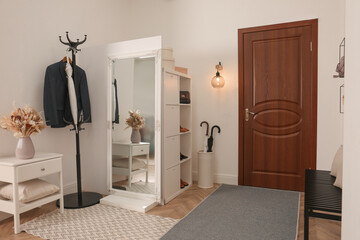 Fototapeta na wymiar Modern hallway interior with stylish furniture and mirror