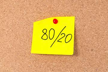Pareto principle or 80 20 rule represented on a sticky note - a reminder or advice