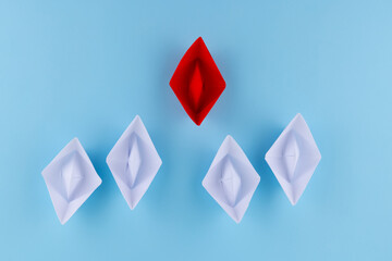 red and white paper boats on a blue background