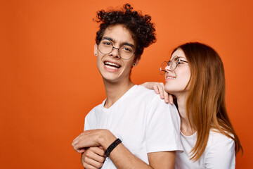 young couple in white t-shirts and glasses fun communication joy