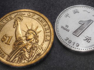 Translation: People's Bank of China, one yuan. The American 1 dollar coin and the Chinese 1 yuan coin. Dark aged illustration. Close-up. Economic rivalry between the United States and China. Macro