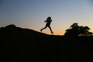 silhouettes of people in the mountain with sunrise sky background