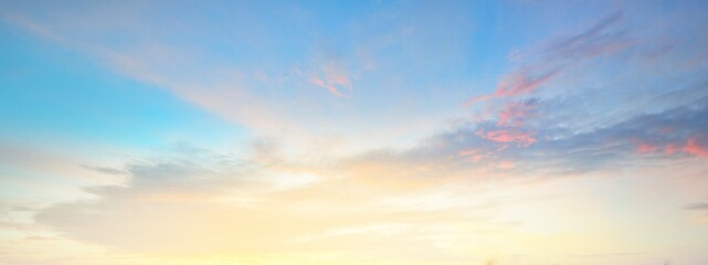 Clear blue sky. glowing pink and golden cirrus and cumulus clouds after storm, soft sunlight. Dramatic sunset cloudscape. Meteorology, heaven, peace, graphic resources, picturesque panoramic scenery - obrazy, fototapety, plakaty