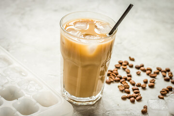 Ice coffee with milk and beans for lunch on stone background