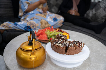 Dessert table with fruit, cake and hot beverage