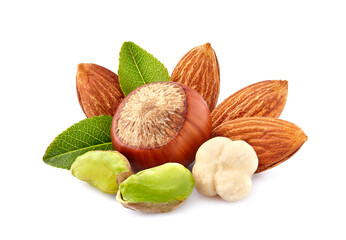 Almonds, pistachios and hazelnuts  with leaves in closeup isolated on white background.