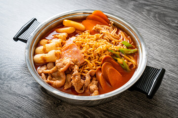 Budae Jjigae or Budaejjigae (Army stew or Army base stew). It is loaded with Kimchi, spam, sausages, ramen noodles and much more